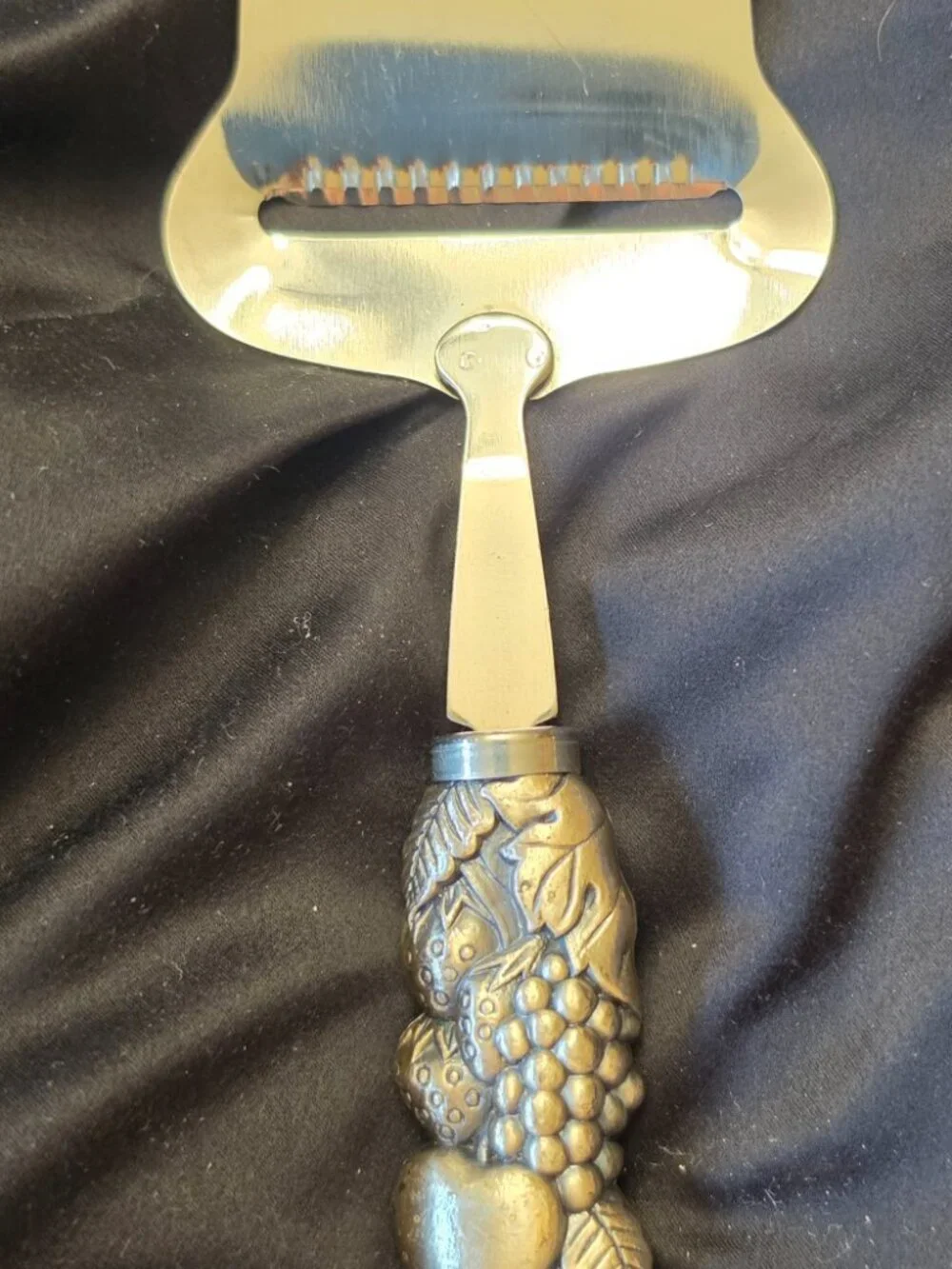 Stainless cheese slicer with fruit/leaf covered nicely weighted handle-kitchen